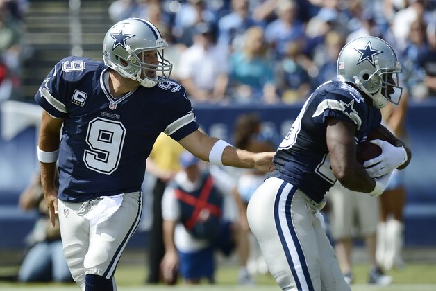 Dallas Cowboys quarterback Tony Romo (9) hands off to running back DeMarco Murray (29) in the first quarter of an NFL football game against the Tennessee Titans Sunday, Sept. 14, 2014, in Nashville, Tenn. (AP Photo/Mark Zaleski)