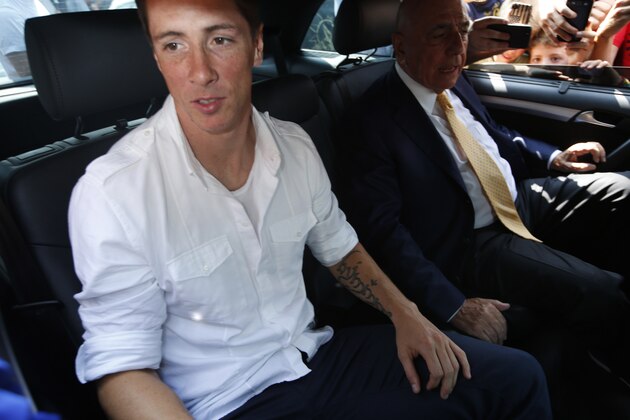 Spanish striker Fernando Torres, left, sits in a car next to AC Milan CEO Adriano Galliani shortly after arriving at Linate airport, Milan, Italy, Saturday, Aug. 30, 2014. Chelsea has agreed terms with AC Milan for Torres to join the Serie A club in a two-year loan deal. The Premier League club and Milan announced the agreement on their websites Friday, adding that