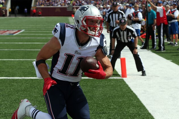 New England Patriots wide receiver Julian Edelman catches a 9-yard touchdown pass  during the second quarter of an NFL football game against the Minnesota Vikings Sunday, Sept. 14, 2014, in Minneapolis. (AP Photo/Jim Mone)