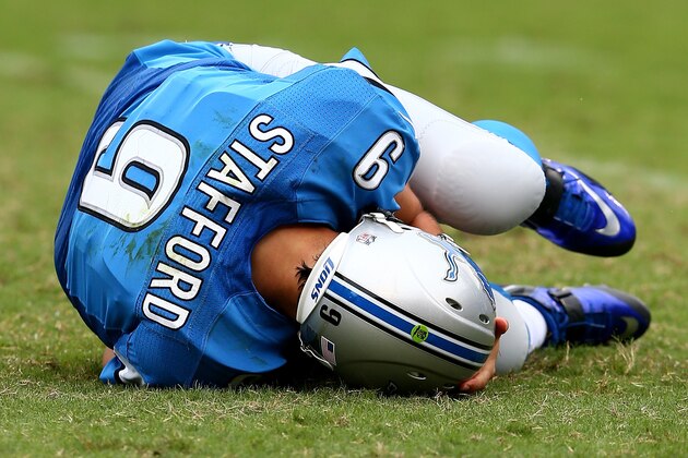 CHARLOTTE, NC - SEPTEMBER 14:   Matthew Stafford #9 of the Detroit Lions hits the ground after a play against the Carolina Panthers during the game at Bank of America Stadium on September 14, 2014 in Charlotte, North Carolina.  (Photo by Streeter Lecka/Getty Images)