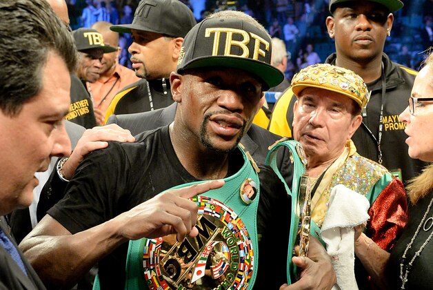 Sep 13, 2014; Las Vegas, NV, USA; Floyd Mayweather celebrates in the ring after defeating Marcos Maidana (not pictured) in their WBC & WBA Welterweight and WBC Superwelter Weight title fight at the MGM Grand Garden Arena. Mandatory Credit: Jayne Kamin-Oncea-USA TODAY Sports