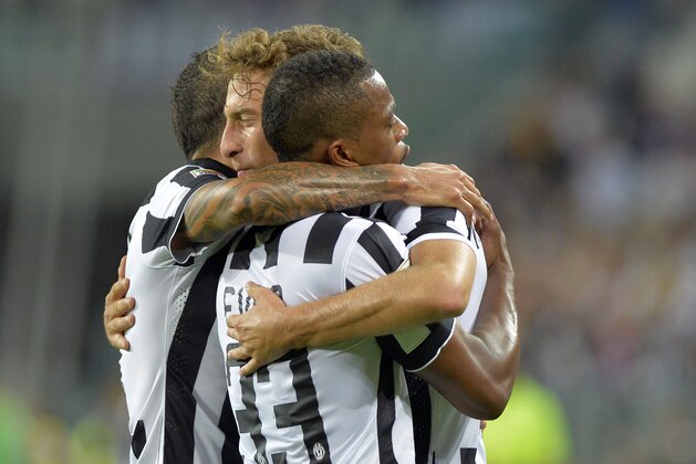 Juventus Claudio Marchisio celebrates with his teammates after scoring during a Serie A soccer match between Juventus and  Udinese at the Juventus stadium, in Turin, Italy, Saturday, Sept. 13, 2014. (AP Photo/Massimo Pinca)