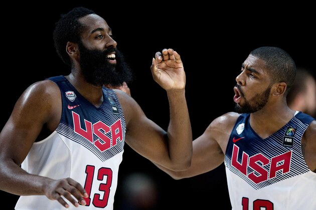 MADRID, SPAIN - SEPTEMBER 14: James Harden (L) of the USA celebrates scoring with teammate Kyrie Irving (R) during the 2014 FIBA World Basketball Championship final match between USA and Serbia at Palacio de los Deportes on September 14, 2014 in Madrid, Spain.  (Photo by Gonzalo Arroyo Moreno/Getty Images)