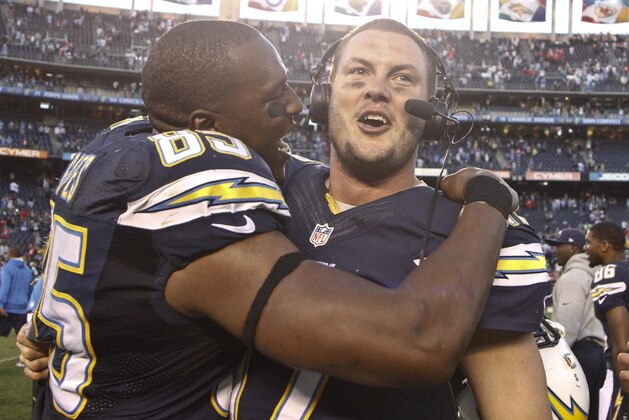 San Diego Chargers tight end Antonio Gates hugs quarterback Philip Rivers after the Chargers made the playoffs with a 27-24 overtime victory over the Kansas City Chiefs in an NFL football game Sunday, Dec. 29, 2013, in San Diego. (AP Photo/Lenny Ignelzi )