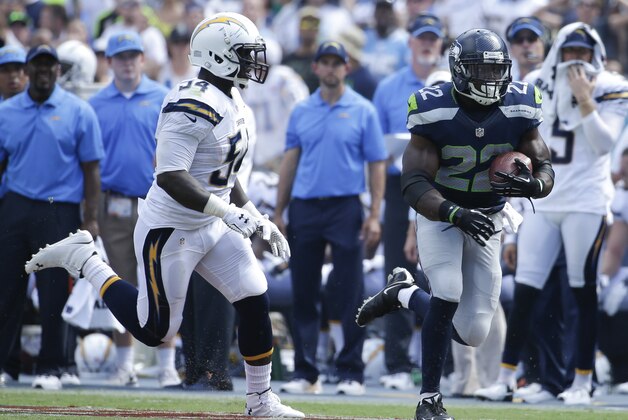 Seattle Seahawks Robert Turbin, right, runs past San Diego Chargers outside linebacker Melvin Ingram during the first half of an NFL football game on Sunday, Sept. 14, 2014, in San Diego. (AP Photo/Gregory Bull)