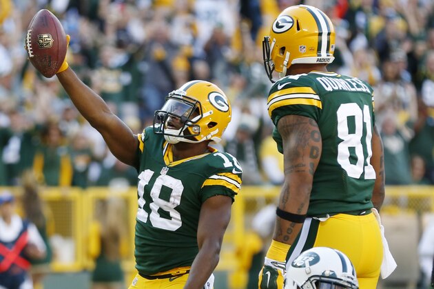 Green Bay Packers' Randall Cobb celebrates a touchdown catch in front of New York Jets' Kyle Wilson (20) during the first half of an NFL football game Sunday, Sept. 14, 2014, in Green Bay, Wis. (AP Photo/Tom Lynn)