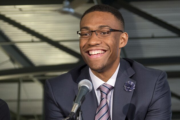 Milwaukee Bucks first round draft pick Jabari Parker is flanked by coach Larry Drew, left, and general manager John Hammond as he is introduced at a news conference Friday, June 27, 2014, in Milwaukee. (AP Photo/Morry Gash)