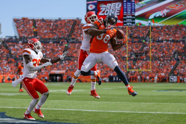 DENVER, CO - SEPTEMBER 14: Wide receiver Demaryius Thomas #88 of the Denver Broncos has a second quarter 12 yard touchdown catch under coverage by free safety Husain Abdullah #39 of the Kansas City Chiefs and cornerback Chris Owens #20 at Sports Authority Field at Mile High on September 14, 2014 in Denver, Colorado. (Photo by Justin Edmonds/Getty Images)