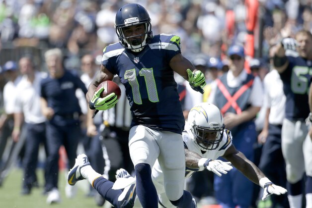 Seattle Seahawks wide receiver Percy Harvin, top,  scores past San Diego Chargers cornerback Richard Marshall during the first half of an NFL football game on Sunday, Sept. 14, 2014, in San Diego. (AP Photo/Gregory Bull)