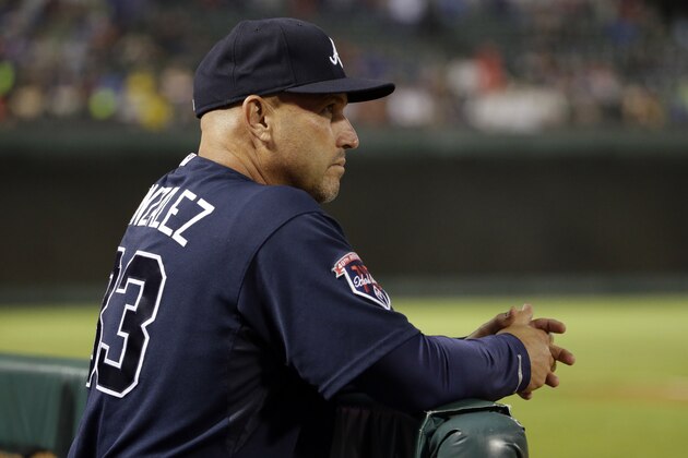 Atlanta Braves manager Fredi Gonzalez watches the Braves' baseball game against the Texas Rangers in the eighth inning Friday, Sept. 12, 2014, in Arlington, Texas. The Rangers won 2-1. (AP Photo/Tony Gutierrez)
