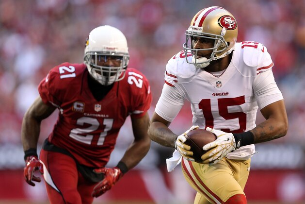 GLENDALE, AZ - DECEMBER 29:   Michael Crabtree #15 of the San Francisco 49ers catches a 14 yard pass by Colin Kaepernick #7 in the second quarter against Patrick Peterson #21 of the Arizona Cardinals during a game at University of Phoenix Stadium on December 29, 2013 in Glendale, Arizona.  (Photo by Christian Petersen/Getty Images)