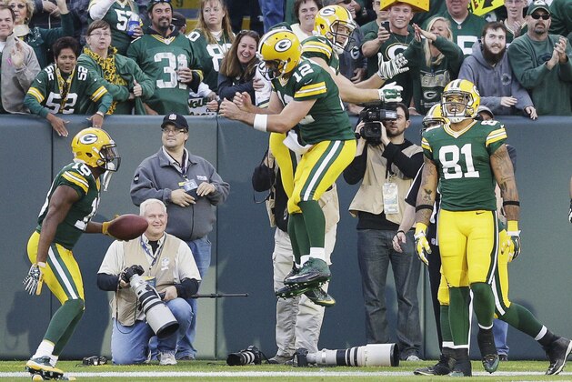 Green Bay Packers' Aaron Rodgers (12) and Jordy Nelson celebrate an 80-yard touchdown pass during the second half of an NFL football game against the New York Jets Sunday, Sept. 14, 2014, in Green Bay, Wis. (AP Photo/Tom Lynn)