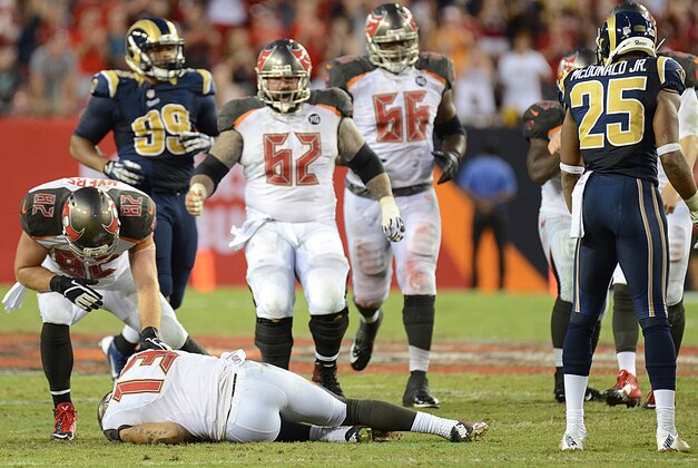 Sep 14, 2014; Tampa, FL, USA; Tampa Bay Buccaneers wide receiver Mike Evans (13) lays on the ground after getting hit by St. Louis Rams defensive back T.J. McDonald (25) on the last play of the game at Raymond James Stadium. Mandatory Credit: Jonathan Dyer-USA TODAY Sports