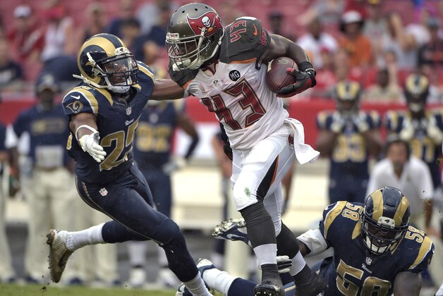 Tampa Bay Buccaneers running back Bobby Rainey (43) runs between St. Louis Rams defenders T.J. McDonald (25) and Jo-Lonn Dunbar (58) during the second quarter of an NFL football game Sunday, Sept. 14, 2014, in Tampa, Fla. (AP Photo/Phelan M. Ebenhack)
