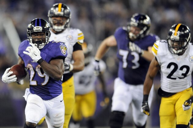 Baltimore Ravens running back Justin Forsett (29) runs away from Pittsburgh Steelers defensive end Cameron Heyward (97) and free safety Mike Mitchell (23) during the second half of an NFL football game Thursday, Sept. 11, 2014, in Baltimore. The Ravens won 26-6. (AP Photo/Gail Burton)