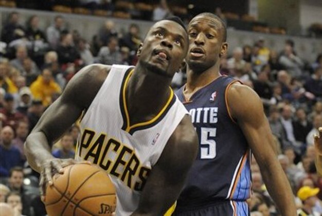Indiana Pacers guard Lance Stephenson, left, drives to the basket while guarded by Charlotte Bobcats guard Kemba Walker (15) in the second half of an NBA basketball game in Indianapolis, Wednesday, Feb. 13, 2013. The Pacers won 101-77. (AP Photo/ Alan Petersime)