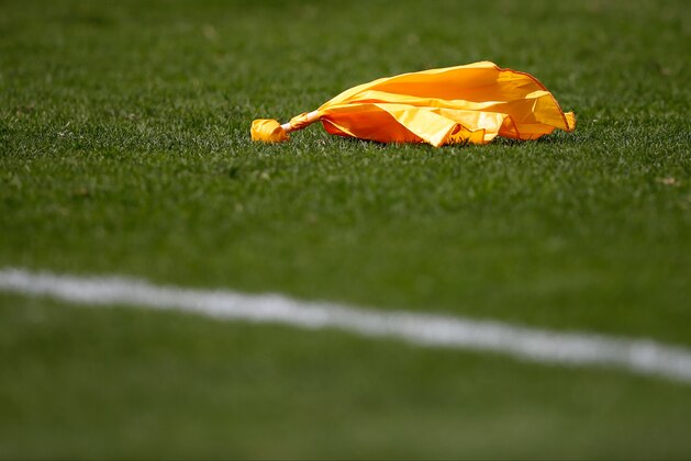 A penalty flag sits on the field during the first half of an NFL football game between the Philadelphia Eagles and the Jacksonville Jaguars, Sunday, Sept. 7, 2014, in Philadelphia. (AP Photo/Matt Rourke)