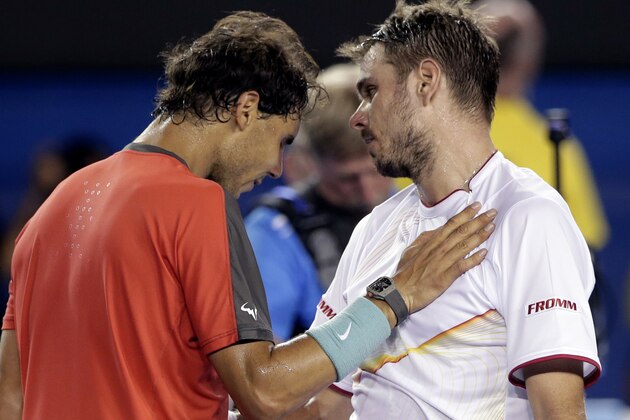 Stanislas Wawrinka of Switzerland, right, is congratulated by Rafael Nadal of Spain at the net after Wawrinka won their men's singles final at the Australian Open tennis championship in Melbourne, Australia, Sunday, Jan. 26, 2014. (AP Photo/Rick Rycroft)