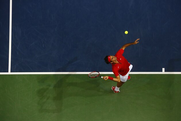 Switzerland's Roger Federer serves a ball during his Davis Cup semifinal tennis match against Italy's Simone Bolelli   in Geneva  Friday Sept. 12, 2014.  (AP Photo/Denis Balibouse,Pool)