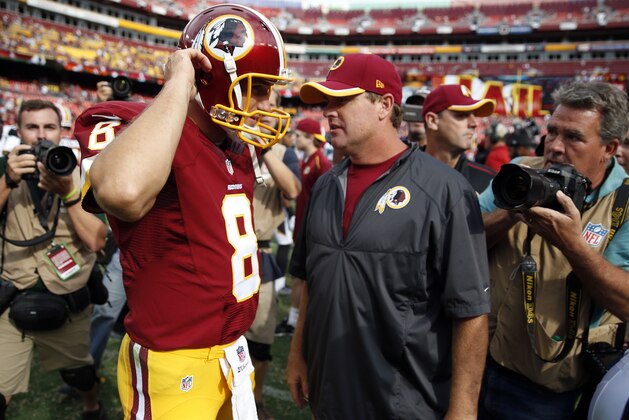 Washington Redskins quarterback Kirk Cousins (8) and head coach Jay Gruden talk after an NFL football game against the Jacksonville Jaguars Sunday, Sept. 14, 2014, in Landover, Md. The Redskins won 41-10. (AP Photo/Evan Vucci)