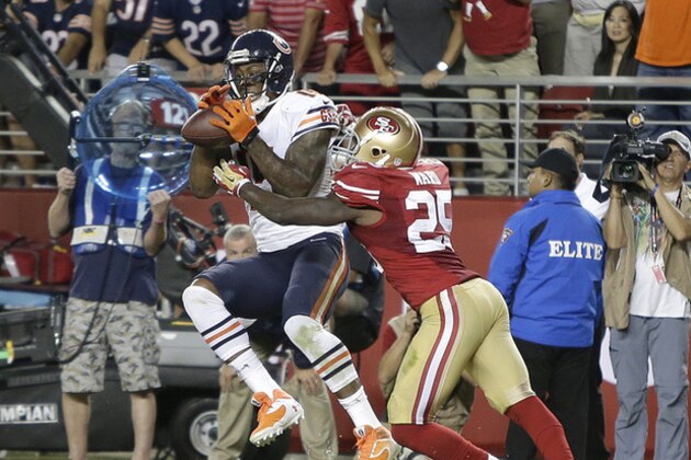 Chicago Bears wide receiver Brandon Marshall (15) catches 3-yard touchdown in front of San Francisco 49ers strong safety Jimmie Ward (25) during the fourth quarter of an NFL football game in Santa Clara, Calif., Sunday, Sept. 14, 2014. (AP Photo/Marcio Jose Sanchez)