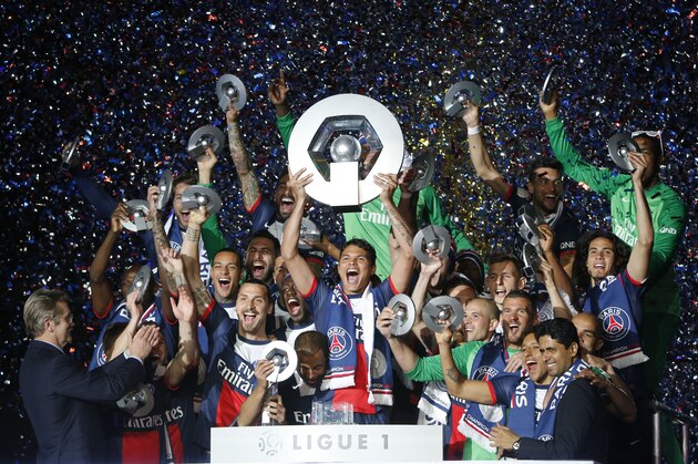 Paris Saint Germain's Thiago Motta holds his trophy with teamates as he celebrates PSG's French League One title, at the Parc des Princes Stadium, in Paris, Saturday, May. 17, 2014.Paris Saint-Germain won the French League One Championship title on Saturday, the 4th in the club's history.(AP Photo/Jacques Brinon)