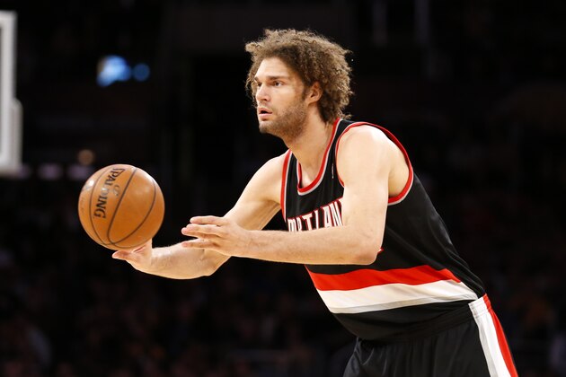 Portland Trail Blazers center Robin Lopez passes the ball against the Los Angeles Lakers during the first half of an NBA basketball game in Los Angeles, Tuesday, April 1, 2014. (AP Photo/Danny Moloshok)