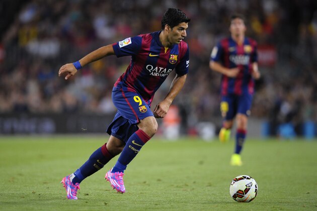 Barcelona's Luis Suarez, from Uruguay, controls the ball during the Joan Gamper trophy friendly soccer match against Leon at the Camp Nou in Barcelona, Spain, Monday, Aug. 18, 2014. (AP Photo/Manu Fernandez)