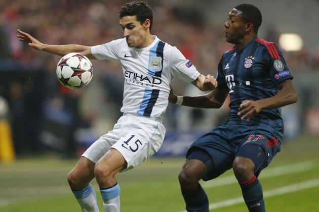 Bayern's David Alaba, right, and Manchester City's Jesus Navas challenge for the ball during the Champions League group D soccer match between FC Bayern Munich and Manchester City, in Munich, southern Germany, Tuesday, Dec. 10, 2013. (AP Photo/Matthias Schrader)