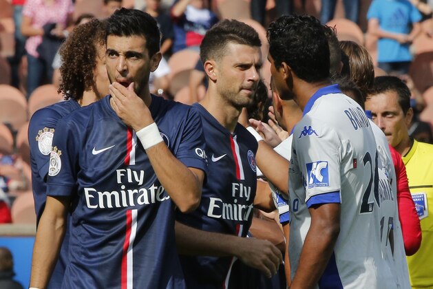 Paris Saint Germain's Thiago Motta, center and Bastia's Brandao, right, greets each other prior to the kick-off of a French League One soccer Match Paris Saint Germain against Bastia, while Argentinian Javier Pastore,left, stands next to them, at Parc des Princes stadium, in Paris, Saturday, Aug. 16. 2014. Paris Saint-Germain President Nasser Al-Khelaifi wants Brandao to be banned for life after the Bastia striker headbutted Thiago Motta at the end of a French league match on Saturday. After Bastia's 2-0 loss to PSG, Brandao waited for Thiago Motta in the tunnel and headbutted the midfielder, leaving him with blood running down from his nose. Al-Khelaifi said the Italian had a broken nose, although the club had not disclosed any injury details. (AP Photo/Michel Euler)