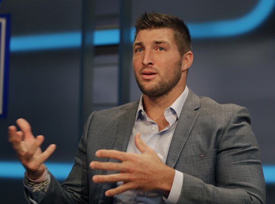 Tim Tebow answers a question during a interview on the set of ESPN's new SEC Network in Charlotte, N.C., Wednesday, Aug. 6, 2014. Tebow has a new job as a commentator for the SEC Network, but is still looking for work in the NFL as a quarterback. (AP Photo/Chuck Burton)