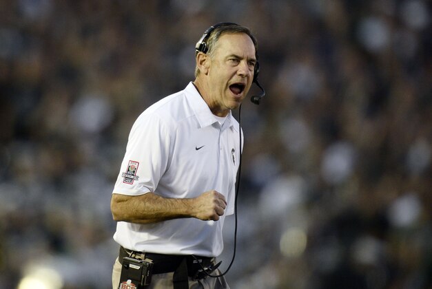 Jan 1, 2014; Pasadena, CA, USA; Michigan State Spartans head coach Mark Dantonio celebrates after Michigan State Spartans wide receiver Tony Lippett (not pictured) scored a touchdown against the Stanford Cardinal during the second half at the Rose Bowl. Mandatory Credit: Robert Hanashiro-USA TODAY Sports