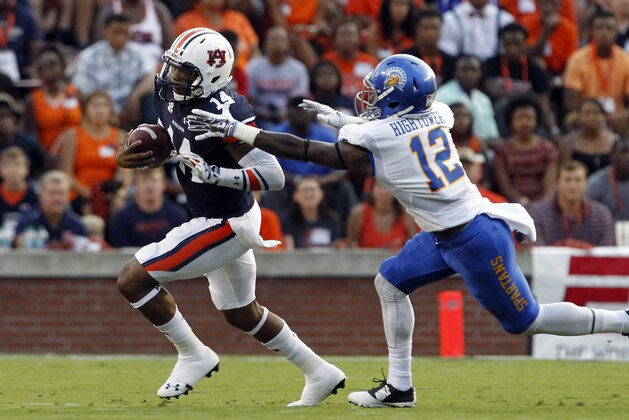 Auburn quarterback Nick Marshall (14) scrambles away from San Jose State safety Forrest Hightower (12) during the first half of an NCAA college football game on Saturday, Sept. 6, 2014, in Auburn, Ala. (AP Photo/Butch Dill)