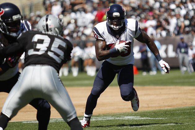 Houston Texans wide receiver Andre Johnson, right, carries the ball as Oakland Raiders defensive back Chimdi Chekwa, left, looks on in the first quarter of an NFL football game Sunday, Sept. 14, 2014, in Oakland, Calif. (AP Photo/Beck Diefenbach)