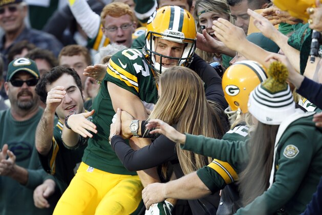 Green Bay Packers' Jordy Nelson celebrates with fans after a touchdown catch during the second half of an NFL football game against the New York Jets Sunday, Sept. 14, 2014, in Green Bay, Wis. (AP Photo/Mike Roemer)