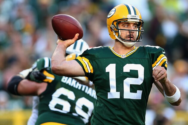 GREEN BAY, WI - SEPTEMBER 14:  Quarterback Aaron Rodgers #12 of the Green Bay Packers throws a pass during the second half of the NFL game against the New York Jets at Lambeau Field on September 14, 2014 in Green Bay, Wisconsin. The Packers defeated the Jets 31-24.  (Photo by Christian Petersen/Getty Images)