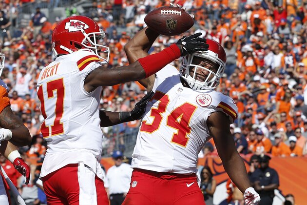 Kansas City Chiefs running back Knile Davis (34) celebrates his touchdown with teammate Donnie Avery against the Denver Broncos during the first half of an NFL football game, Sunday, Sept. 14, 2014, in Denver. (AP Photo/Brennan Linsley)