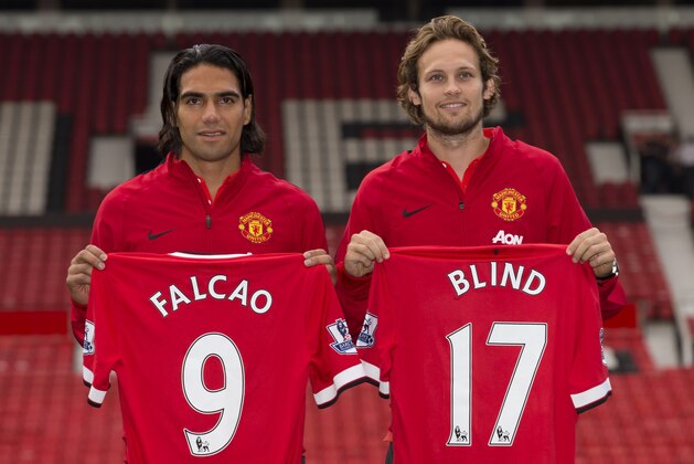 Manchester United's new players Radamel Falcao, left,  and Daley Blind pose for photographs at Old Trafford Stadium, Manchester, England, Thursday Sept. 11, 2014. The Colombian striker Falcao joined on a season-long loan deal from Ligue 1 side Monaco and Blind signed from Ajax as Louis van Gaal looks to bolster his attacking options. (AP Photo/Jon Super)