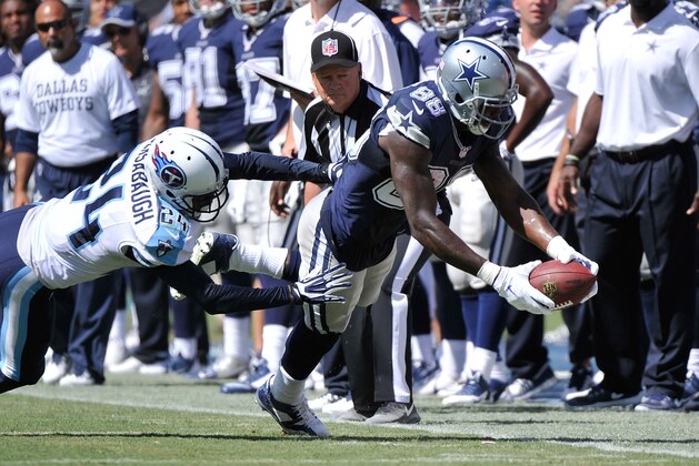 NASHVILLE, TN - SEPTEMBER 14: Dez Bryant #88 of the Dallas Cowboys dives with the ball past Coty Sensabaugh #24 of the Tennessee Titans in the second half of a game at LP Field on September 14, 2014 in Nashville, Tennessee.  (Photo by Frederick Breedon/Getty Images)