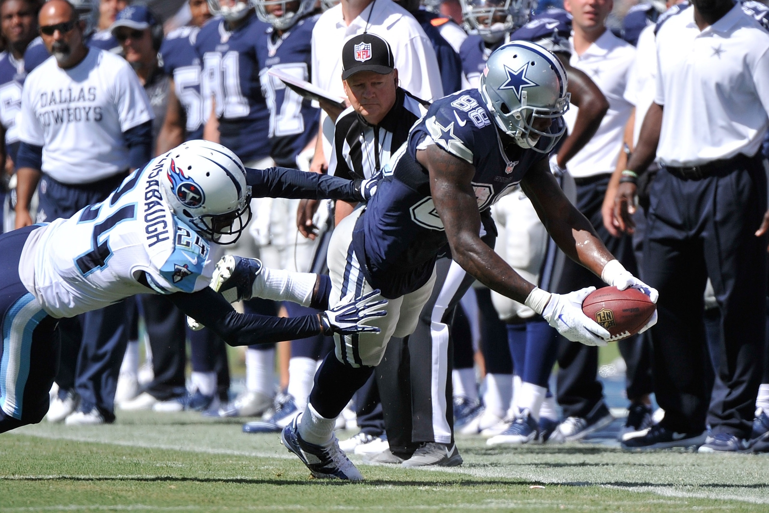 NASHVILLE, TN - SEPTEMBER 14: Dez Bryant #88 of the Dallas Cowboys dives with the ball past Coty Sensabaugh #24 of the Tennessee Titans in the second half of a game at LP Field on September 14, 2014 in Nashville, Tennessee.  (Photo by Frederick Breedon/Getty Images)