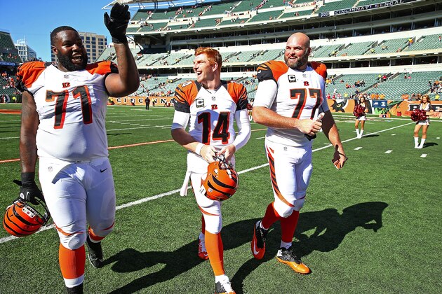 CINCINNATI, OH - SEPTEMBER 14:  Andre Smith #71, Andy Dalton #14, and Andrew Whitworth #77 of the Cincinnati Bengals walk off of the field after defeating the Atlanta Falcons 24-10 at Paul Brown Stadium on September 14, 2014 in Cincinnati, Ohio. (Photo by Andy Lyons/Getty Images)