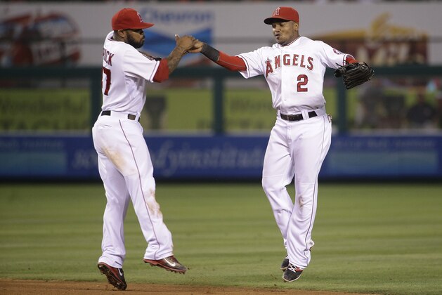 Los Angeles Angels' Erick Aybar, right, and Howie Kendrick celebrate their team's 5-2 win against the Houston Astros in a baseball game Saturday, Sept. 13, 2014, in Anaheim, Calif. (AP Photo/Jae C. Hong)