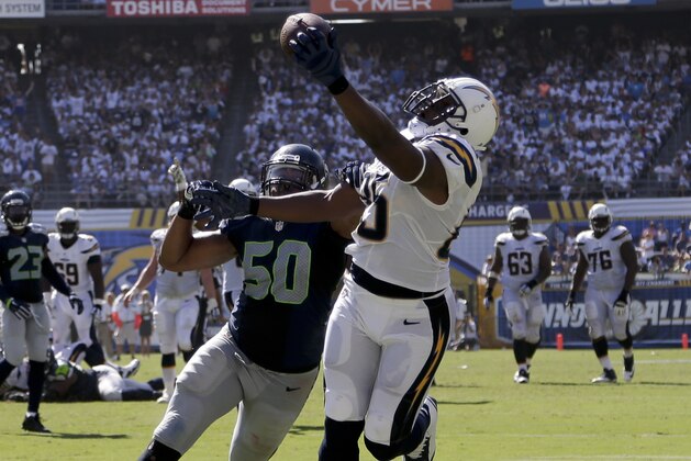 San Diego Chargers tight end Antonio Gates hauls in a touchdown catch as Seattle Seahawks outside linebacker K.J. Wright defends during the second half of an NFL football game on Sunday, Sept. 14, 2014, in San Diego. (AP Photo/Gregory Bull)