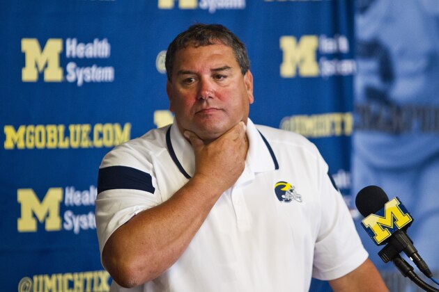Michigan head coach Brady Hoke reacts to reporters' questions during a press conference at the NCAA college football team's preseason media day, Sunday, Aug. 10, 2014, in Ann Arbor, Mich. (AP Photo/Tony Ding)