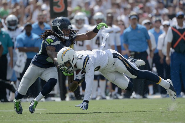 SAN DIEGO, CA - SEPTEMBER 14:  Wide receiver Keenan Allen #13 of the San Diego Chargers catches a pass while defended by cornerback Richard Sherman #25 of the Seattle Seahawks at Qualcomm Stadium on September 14, 2014 in San Diego, California.  (Photo by Donald Miralle/Getty Images)