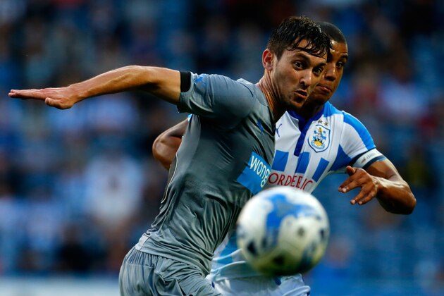 HUDDERSFIELD, ENGLAND - AUGUST 5: Lee Peltier (R) of Huddersfield in action with Facundo Ferreyra of Newcastle during the Pre Season Friendly match between Huddersfield Town and Newcastle United at the John Smith's Stadium on August 5, 2014 in Huddersfield, England. (Photo by Paul Thomas/Getty Images)
