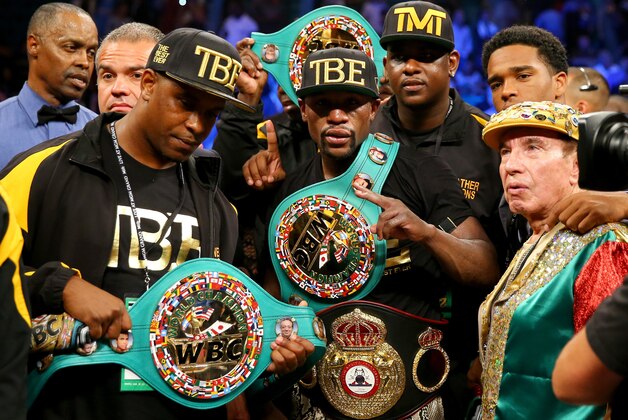 LAS VEGAS, NV - SEPTEMBER 13:  Floyd Mayweather Jr. celebrates his unanimous-decision victory over Marcos Maidana during their WBC/WBA welterweight title fight at the MGM Grand Garden Arena on September 13, 2014 in Las Vegas, Nevada.  (Photo by Al Bello/Getty Images)