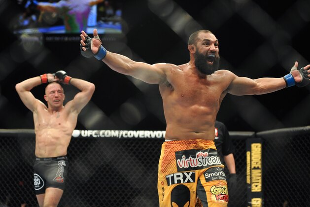 Nov 16, 2013; Las Vegas, NV, USA; Georges St-Pierre (red gloves) and Johny Hendricks (blue gloves) react after their welterweight championship bout during UFC 167 at MGM Grand Garden Arena. Mandatory Credit: Stephen R. Sylvanie-USA TODAY Sports