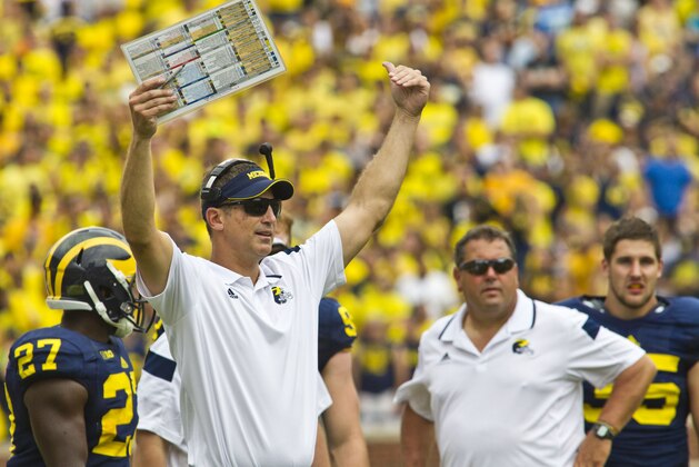 Michigan offensive coordinator Doug Nussmeier, front, signals to his players on the field from the sideline in the third quarter of an NCAA college football game against Appalachian State in Ann Arbor, Mich., Saturday, Aug. 30, 2014. Michigan won 52-14. (AP Photo/Tony Ding) Michigan offensive coordinator Doug Nussmeier, front, signals to his players on the field from the sideline in the third quarter of an NCAA college football game against Appalachian State in Ann Arbor, Mich., Saturday, Aug. 30, 2014. Michigan won 52-14. (AP Photo/Tony Ding)