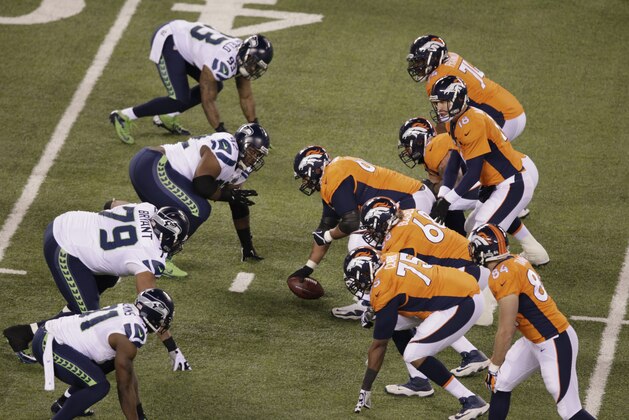 Denver Broncos' Peyton Manning (18) works against the Seattle Seahawks  during the first half of the NFL Super Bowl XLVIII football game Sunday, Feb. 2, 2014, in East Rutherford, N.J. (AP Photo/Charlie Riedel)